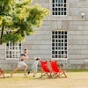 Family playing on lawn with deckchairs